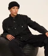 Camisa masculina Blue Steel de corte oversized tipo boxy, confeccionada en denim de algodón con efecto marmolado. Presenta cuello camisero, mangas largas, cierre frontal con botones metálicos y dos bolsillos con solapa en el pecho.