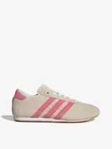 Championes Adidas Taekwondo Lace color crema con las tres tiras laterales en rosa.
