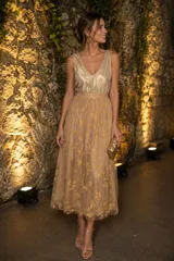 Pollera midi de tul color dorado con falda vaporosa y delicados detalles de flores bordadas en tono sobre tono.