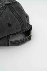 Gorra con visera de estilo vintage, color gris oscuro con efecto lavado, con bordado frontal en color crema.