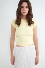 Camiseta básica entallada de manga corta, confeccionada en tejido elástico de punto con cuello redondo.