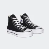 Championes Converse Chuck Taylor All Star Platform Hi de lona negra con plataforma alta, puntera de goma blanca y el icónico parche con estrella en el tobillo.