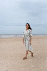 Túnica a rayas verticales anchas color gris y blanco, con mangas cortas y lazo en la cintura.