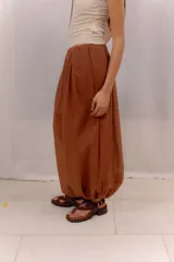 Pantalón tipo bombacha color marrón terracota, de corte ancho y relajado, con cintura elástica y bolsillos laterales.