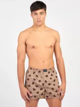 Bóxer de algodón blanco con estampado de flores pequeñas color celeste, con cintura elástica y logo de la marca en el centro.