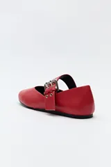 Balerina roja de cuero sintético con punta ligeramente afilada y tira ancha con hebilla metálica.
