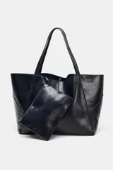 Bolso formato maxi shopper de piel con acabado brillante, detalle de pespuntes a tono y asas de hombro. Incluye una cartera extraíble con cierre y logo de la marca grabado.