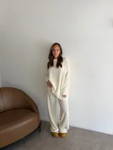 Conjunto de dos piezas compuesto por una remera de manga larga y un pantalón de corte recto, ambos confeccionados en tejido de punto texturizado color marrón.