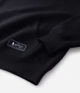 Buzo con capucha de corte boxy, confeccionado en tejido fleece. Presenta una estampa artística en la espalda que ilustra a un jugador de fútbol y firma bordada en el pecho.