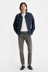 Jean skinny de hombre color gris oscuro, de tiro medio, con lavado desgastado y sin elasticidad.