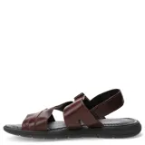 Sandalias de cuero marrón con tiras cruzadas y cierre de velcro en el talón, montadas sobre una suela ergonómica negra.