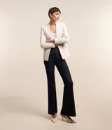 Blazer color crema en tejido tweed, de corte recto, sin solapa, con cierre frontal de un botón y bolsillos con solapa.