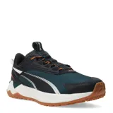 Championes de trail running Puma modelo Extend Lite, con capellada de malla en color verde oscuro y detalles en negro. Presentan mediasuela de EVA blanca para amortiguación, suela de goma color caramelo con tacos para mayor tracción y cordones con detalles en naranja.