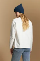 Remera de manga larga con calce relajado y cuello redondo, confeccionada en algodón de color blanco.