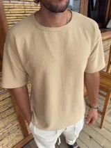 Remera de manga corta con textura tipo waffle, cuello redondo y corte holgado.