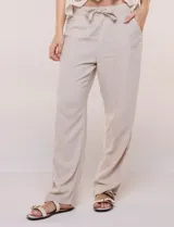 Pantalón de lino blanco, marca Dash, con pretina ancha elastizada, lazo de ajuste y bolsillos inclinados en el frente.
