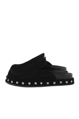 Zuecos tipo mule de cuero gamuzado negro, con plataforma forrada y detalle de tachas plateadas en el contorno. Presentan una plantilla con el logo bordado.