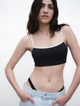 Top de bikini estilo deportivo con escote recto y tirantes finos en contraste. Confeccionado en tejido texturizado con protección UV.