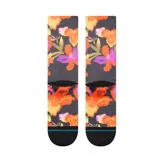 Par de medias Stance con estampado de flores en tonos naranja, violeta y verde sobre fondo negro.