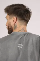 Remera de manga corta, corte oversize, color gris oscuro con efecto lavado o acid wash.