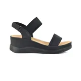 Sandalias negras con plataforma y tiras elásticas cruzadas.