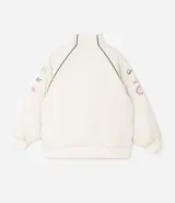 Campera bomber de microfibra color beige con estampado frontal de lettering 'PARIS 1985'. Presenta cierre frontal con cremallera, cuello alto, bolsillos funcionales y puños y ruedo ajustados con elástico.