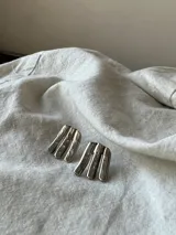 Par de caravanas hechas a mano en bronce dorado, con forma de ramitas.