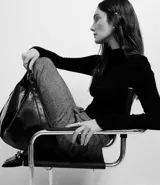 Blusa negra de rib de viscosa sostenible, con cuello alto y mangas largas.