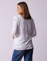 Blusa blanca con bordado calado tipo broderie, de mangas largas abullonadas.