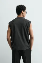 Camiseta tank gris con efecto lavado, de corte relajado, cuello redondo y manga raglán sisa.