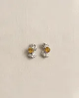 Aros abridores elaborados en plata 950 con diseño de formas orgánicas y textura irregular, engarzando un cristal facetado en tono amarillo en el centro.