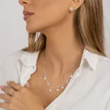 Aros de plata 925 con tres piedras de la luna y un topacio blanco central.