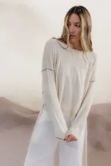 Sweater color crema con rayas horizontales y mangas largas.