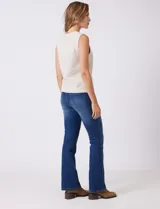 Buzo sin mangas color beige, de tejido melange suave, con cuello a la base y sisas amplias. Presenta pequeños tajos en el ruedo para una mejor caída.