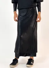 Conjunto plateado brillante de top con breteles finos y pollera larga con efecto mojado.