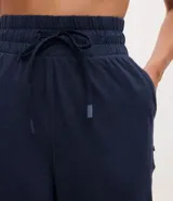 Pantalón de jogging deportivo azul con cintura ajustable con cordón, bolsillos laterales y tobillos ajustados.