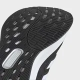 Championes de running Adidas Ultrarun 5, color negro con tres franjas blancas características en el lateral. Presentan una suela gruesa blanca con textura y detalles en negro en la parte inferior.