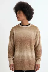 Sweater de tejido de punto con diseño degradé en tonos azules y beige, de corte holgado, cuello redondo y mangas largas.