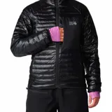 Campera puffer negra de Mountain Hardwear, con diseño acolchado, cierre frontal completo, cuello alto y bolsillo con cierre en el pecho. Cuenta con puños elásticos en color lila y ajuste en el dobladillo.
