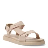 Sandalias tipo papete color beige, con tiras de tela ajustables mediante velcro y suela plana de goma.