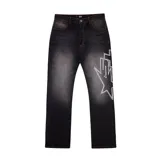 Pantalón de jean negro con efecto lavado y estampado de estrella con strass en la pierna derecha.