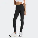 Calza deportiva larga de tiro alto, color negro, con bolsillos laterales en las piernas y tecnología de secado rápido NB DRY.