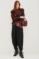 Pantalón tipo babucha de corte holgado y tiro alto, con cintura elástica y diseño de pierna amplia que se estrecha hacia los tobillos.