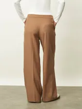 Pantalón de vestir color tostado, de corte recto y pierna ancha, con cintura elástica y cordón ajustable frontal.