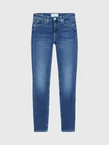 Jeans de denim azul medio vintage, corte skinny, tiro medio, cinco bolsillos y cierre con cremallera.