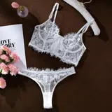 Conjunto de lencería de dos piezas en encaje blanco, compuesto por un corpiño tipo bustier con aro y tirantes regulables, y una bombacha cavada con detalles de tul y encaje floral.