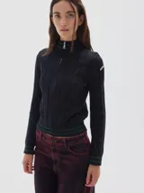 Saco de punto color azul marino con tejido de ochos, cierre frontal, cuello alto y rayas verdes en puños y cuello.