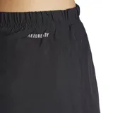 Shorts de running para mujer, color negro, con calzón interior de malla y detalles reflectantes. Presenta un corte ajustado con cintura elástica de tiro alto y ribetes de color verde lima en el borde inferior.