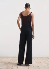 Pantalón wide leg de tiro alto en tejido de algodón estilo denim, color azul marino, con trabillas, cuatro bolsillos y cierre oculto con botón, gancho y cremallera.