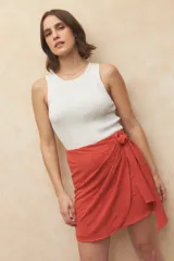 Minifalda negra con diseño cruzado y lazo lateral.